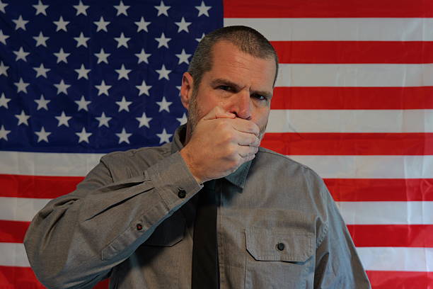 American Censorship Concept - Male Journalist or Politician - See no evil, Speak no evil, Hear no evil idea - Distracted Citizens