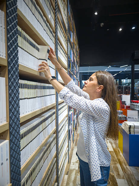 istock Young Woman Browsing Bookshelf in a Bookstore. 2236601240