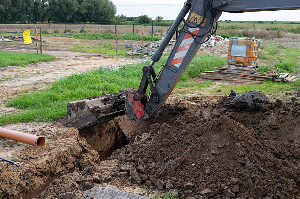 istock Excavator digging trench at construction site for utility installation in rural area. 2236601494