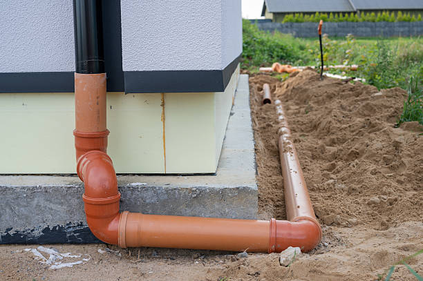 istock Residential Drainage Pipe Installation Along House Foundation. 2236602121
