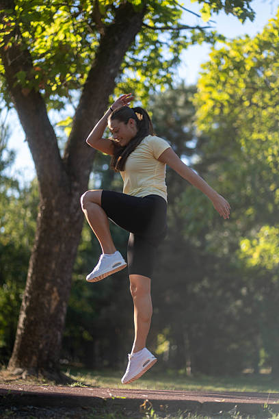 istock Fit young woman jumping and running 2236602457