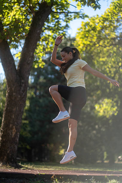 istock Fit young woman jumping and running 2236602459