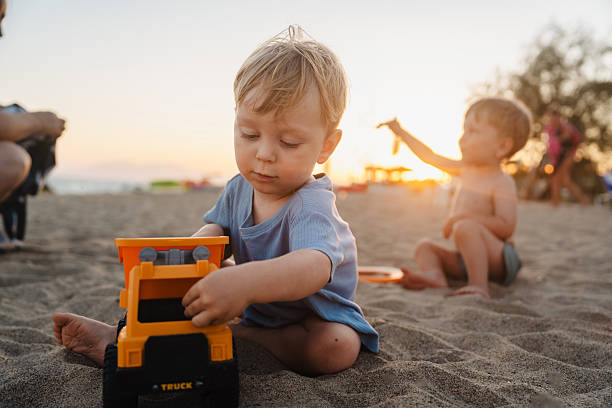 little boy playing with toy car