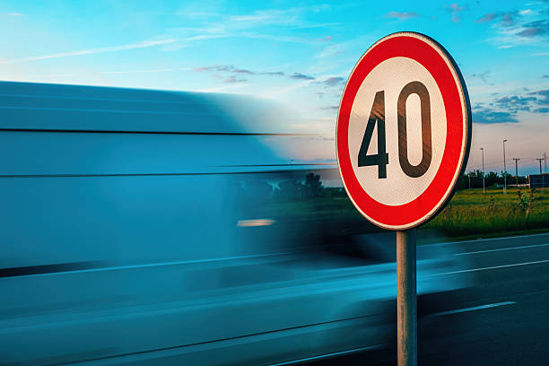 Van speeding by the speed limit traffic sign, motion blur image stock photo