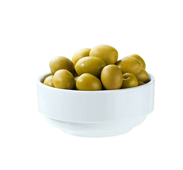 istock green olives in a white ceramic bowl isolated on a white background. 2236608321