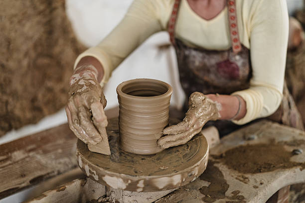 istock Focus on hands of female potter making flower pot 2236612633