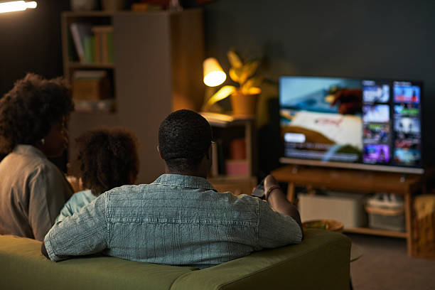 istock Black Family Sitting Together Watching Streaming Content on Television Screen 2236614268