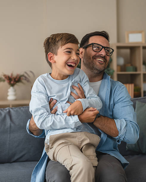 istock Father and son laughing together enjoying playful moment 2236614672