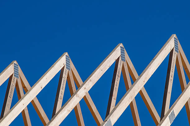 Detailed view of wooden beam structure joint in an architectural framework, showcasing the craftsmanship and intricate woodworking in a construction project.