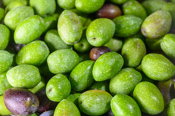 istock Fresh Green Cypriot Olives on Rustic Wooden Surface 2236620605
