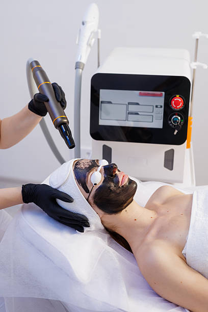 istock Carbon laser peeling in clinic with protective goggles and device closeup 2236622117