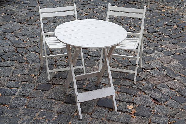 istock White wooden table and outdoor cafe chairs 2236624497