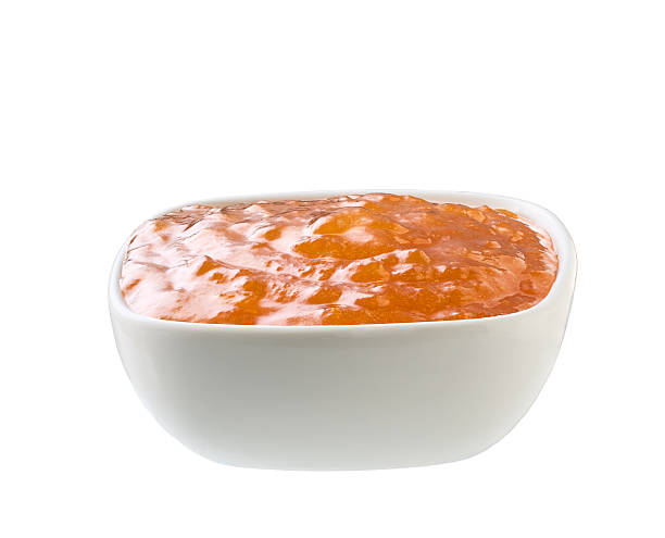 istock orange jam in a white ceramic  bowl isolated on white background. 2236625548