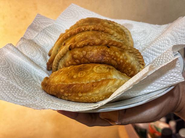 istock A crispy, savory fried pastry from Makassar, filled with chicken, potatoes, and carrots. A perfect warm snack for any occasion. 2236627748
