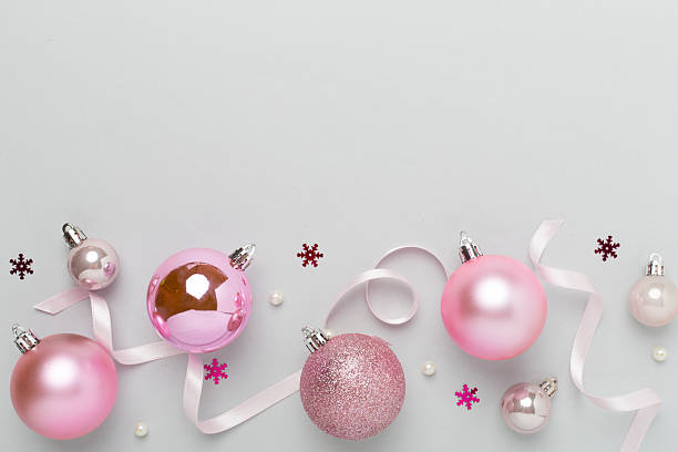istock Pink christmas balls with decor on color background, top view 2236629875