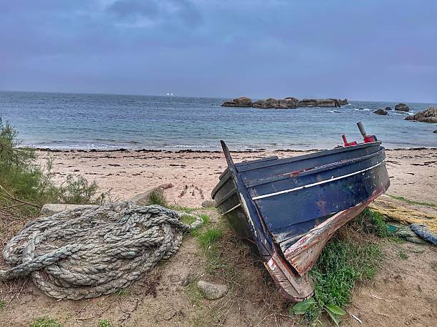 A rowboat stranded on a beach in Galicia.