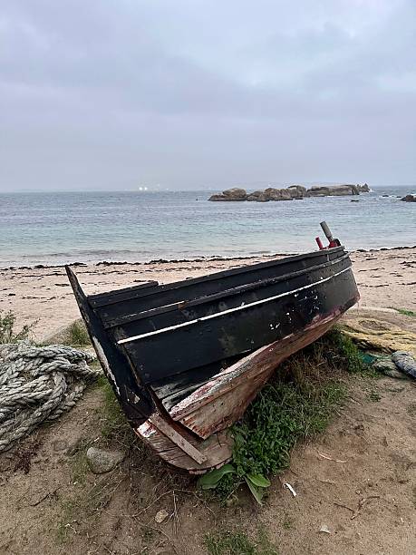 istock Wooden boat stranded on a beach in Galicia 2236631935