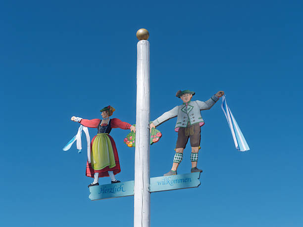 Traditional Folk Art Figures Welcoming Visitors Under Clear Blue Sky