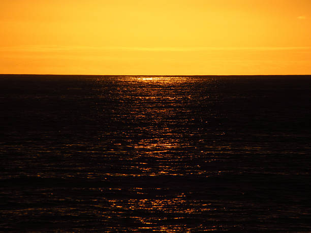 Dark Ocean Water Near Sunset with Sun Reflections