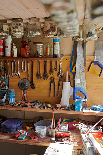 istock Organized workshop bench with tools and storage jars in natural lighting. From Great-grandfather's abandoned workshop. 2236640220