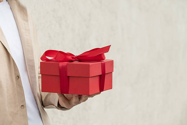 istock Person giving red gift box in hand. Valentines Day. 2236640539