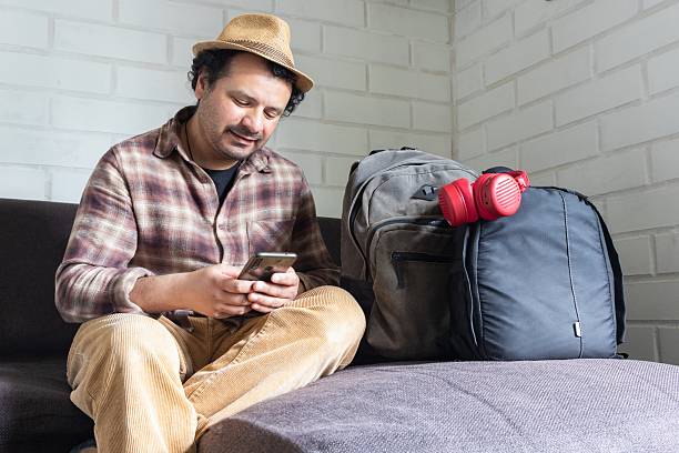 istock latino man sitting preparing to travel 2236642018