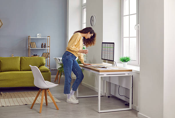 istock Woman accountant working at home, drinking coffee, using her computer, and looking at some papers 2236642536