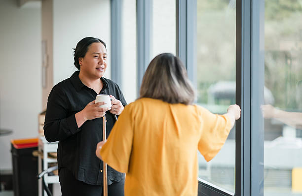 Two female corporate workers collaborates in an office room, exchanging ideas and planning strategies together.