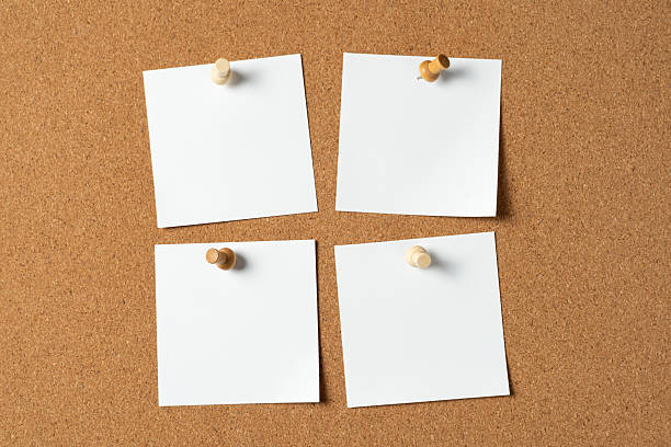 istock Four Notes Pinned on Cork Board with Wooden Push Pins 2236644442