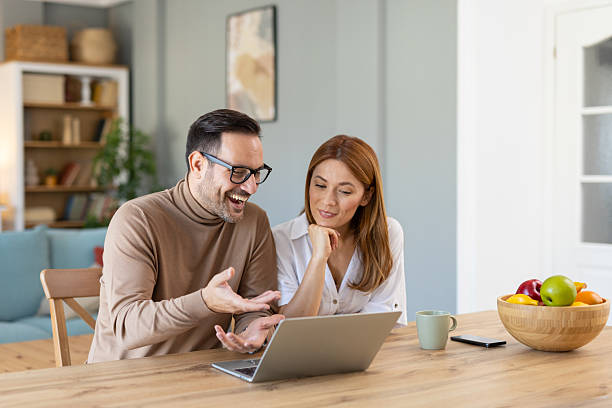 istock Engaging and vibrant couple interaction over a laptop 2236645276