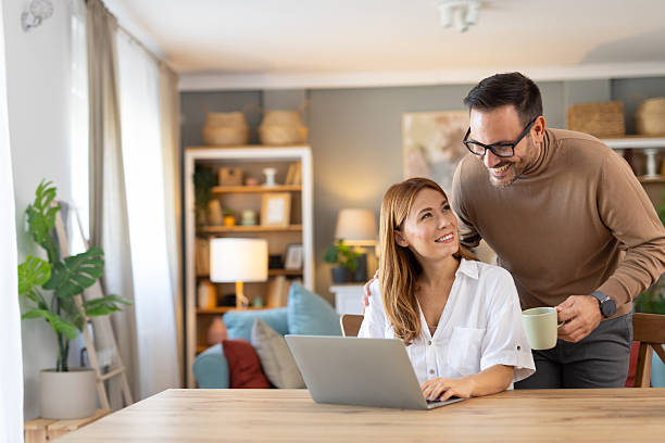 istock Couple Sharing a Happy Moment Over a Laptop in Home Office 2236645286