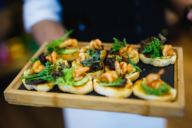 istock Server Presenting a Tray of Gourmet Shrimp Crostini 2236649373