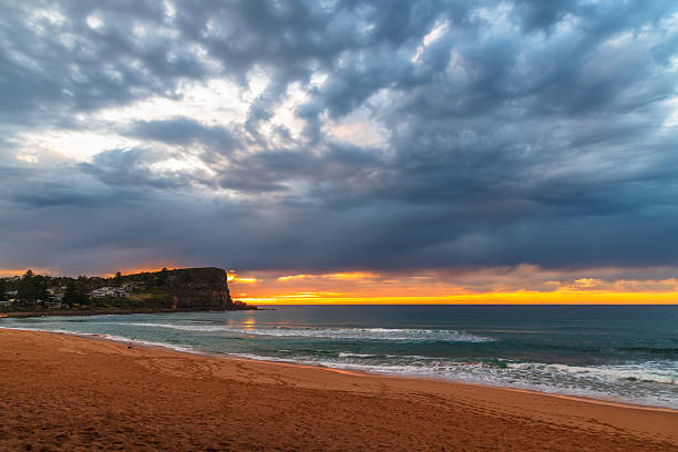 istock Winter sunrise by the sea shore with rain clouds 2236650783