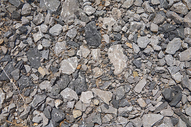 Crushed gray rocks and stone creating a textured surface background