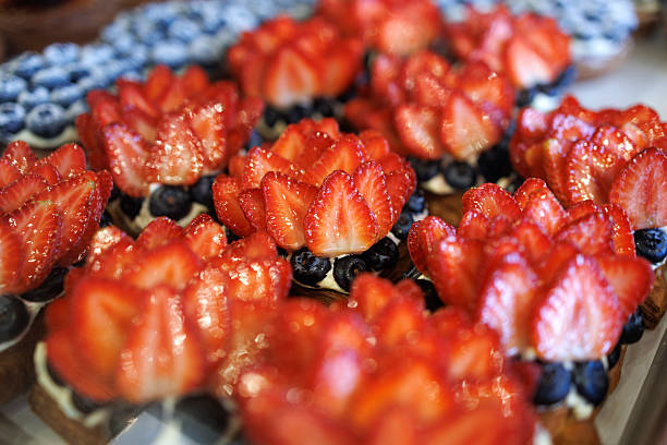 Fresh strawberry and blueberry tarts in bakery display