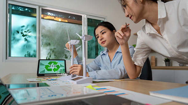 istock ESG Collaboration. Businesswomen discussing sustainability projects with models and data. 2236651185