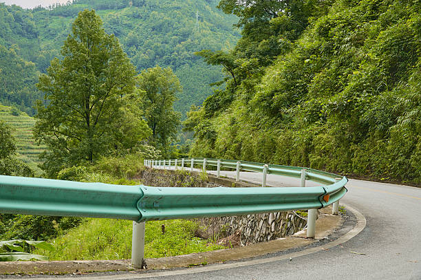 Winding road curving with guardrail protecting the edge of the mountain