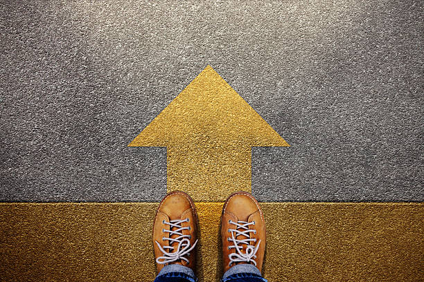 istock Standing at yellow Arrow on the road, Determination, direction, motivation, Start and Growth Mindset to Move Forward. Top View 2236654029