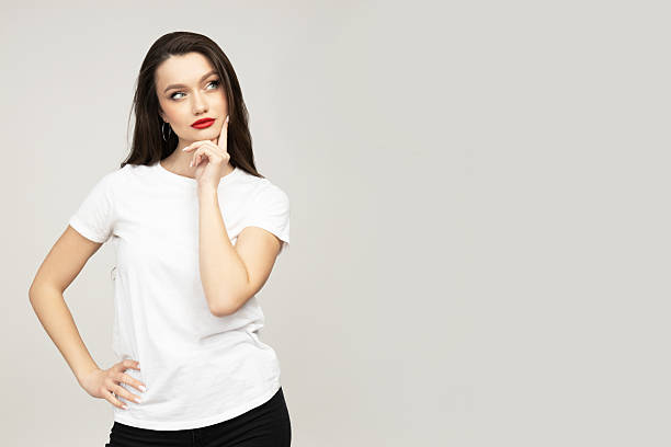 istock Attractive brunette in a white t-shirt is thinking 2236654065