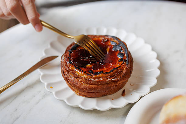 Creme Brulee tart with caramelised top served on white plate in cafe