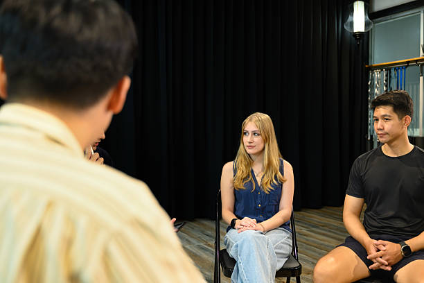 istock Group therapy session with diverse participants seated in a circle, listening attentively to each other 2236655489