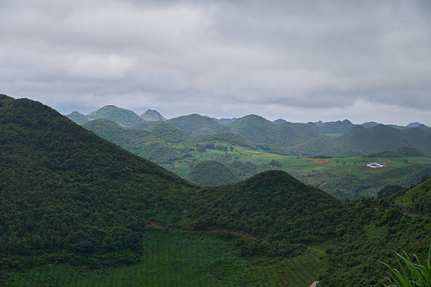istock Rolling green hills under a cloudy sky in a rural landscape 2236661664