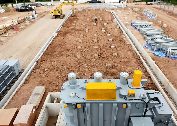 Construction site with concrete slabs and steel reinforcements.