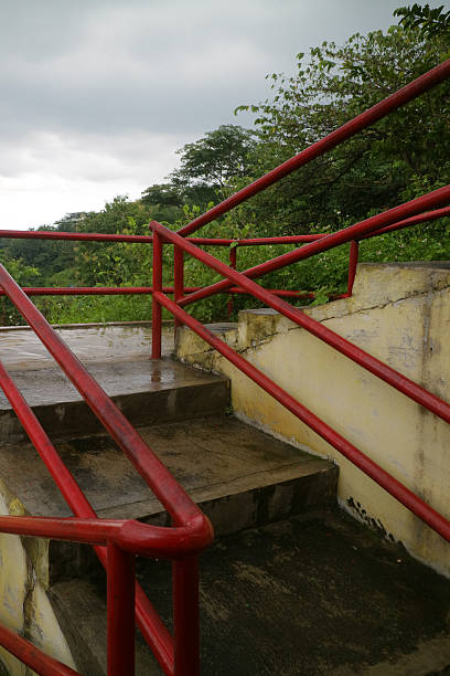 istock Outdoor Staircase with Red Railings and Greenery 2236663736