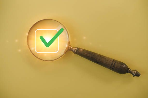 istock Magnifying glass focusing on glowing green check mark icon representing approval, validation, quality assurance, confirmation, verification, success, and positive decision concept 2236665085