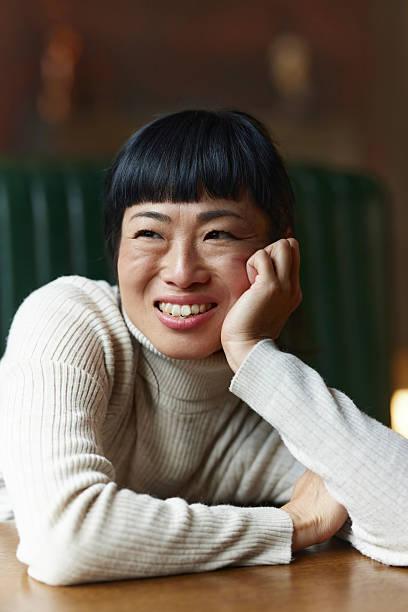 istock Happy Asian woman enjoying while day dreaming. 2236668417