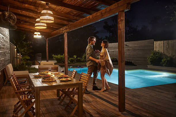 istock Happy couple dancing after dinner date on a patio by the pool. 2236669996