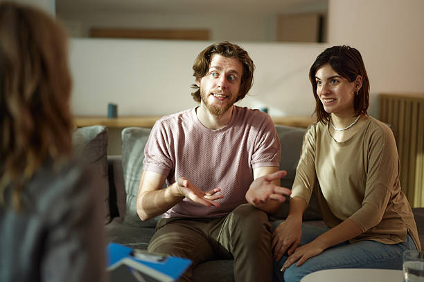 istock Happy couple talking to their agent at home. 2236670309