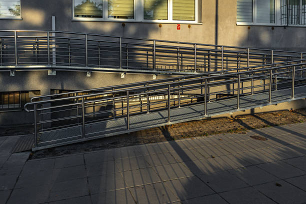 istock Accessible ramp for disabled people, metal ramp with handrails for strollers and disabled people, metal ramp 2236670694