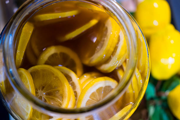 Lemon slices infused in yellow honey jar. Top view